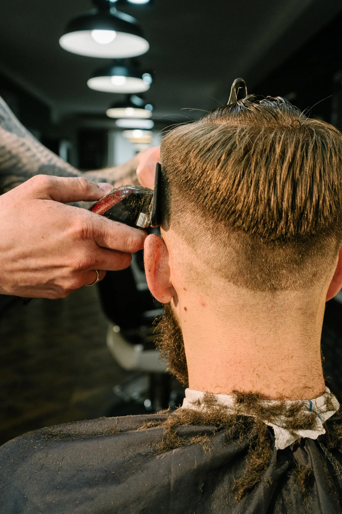 Coiffeur en train de coiffer un client dans un salon